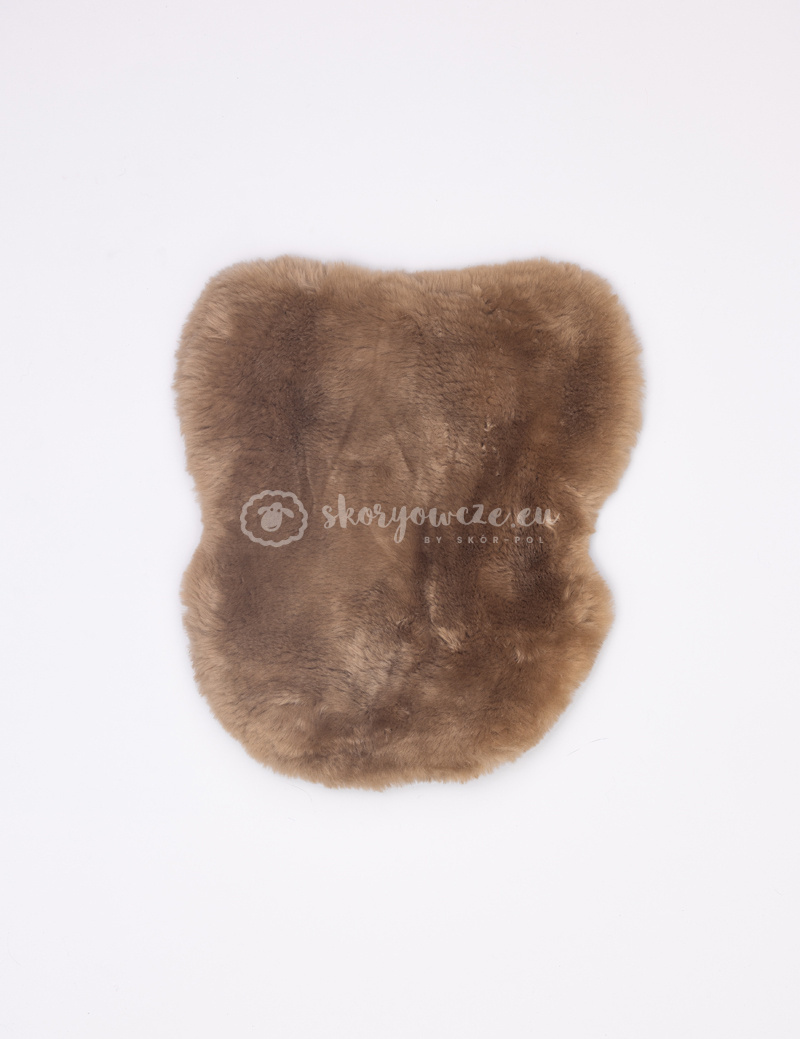 A cover for a horse saddle made of natural sheepskin A cover for a horse saddle made of natural sheepskin